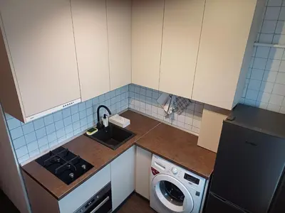 a small kitchen with a sink and a dishwasher at Quiet apartment near park SELF CHECK IN in Šiauliai