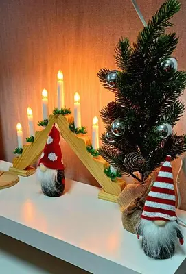 a table with two christmas trees and candles at Quiet apartment near park SELF CHECK IN in Šiauliai