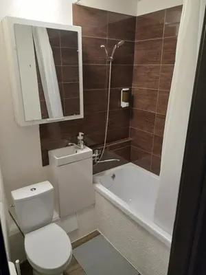 a bathroom with a toilet and a tub and a sink at Quiet apartment near park SELF CHECK IN in Šiauliai