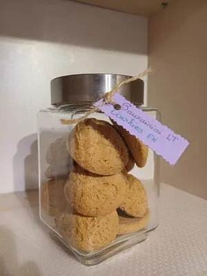 a stack of cookies in a glass jar with a label at Quiet apartment near park SELF CHECK IN in Šiauliai