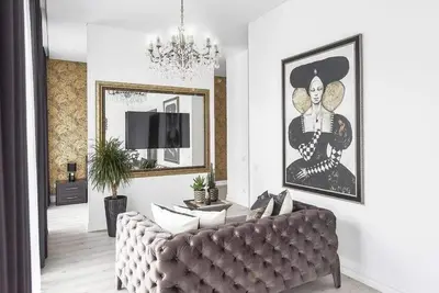a living room with a couch and a chandelier at City center in Kaunas