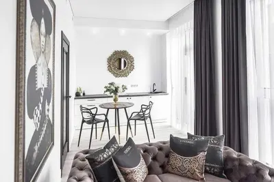 a living room with a couch and a table with chairs at City center in Kaunas