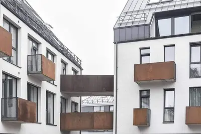 a building with rusty balconies on the side of it at City center in Kaunas