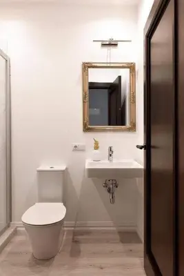 a bathroom with a toilet and a sink and a mirror at City center in Kaunas