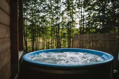 a blue tub filled with water in a yard at Miško kraštas in Vileikiai