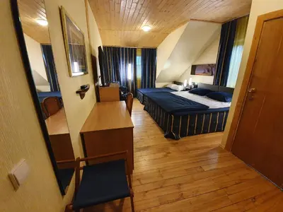a small room with a bed and a desk at Vila Dubysa in Milašaičiai