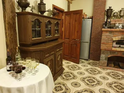 a kitchen with a table with wine glasses on it at Vila Dubysa in Milašaičiai