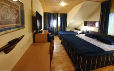 a hotel room with two beds in a room at Vila Dubysa in Milašaičiai