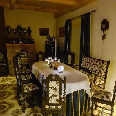 a dining room with a table and two chairs at Vila Dubysa in Milašaičiai