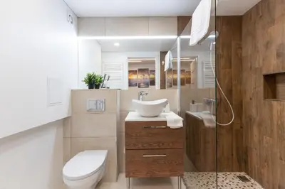 a bathroom with a sink and a toilet and a shower at Newly Refurbished Lukiskiu Square Apartment by Reside Baltic in Vilnius