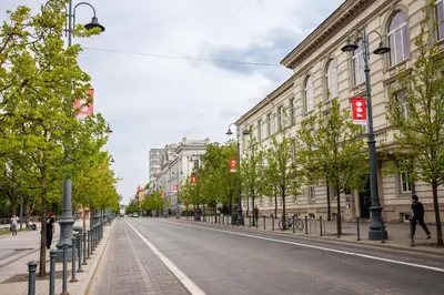 an empty street in a city with buildings at Newly Refurbished Lukiskiu Square Apartment by Reside Baltic in Vilnius