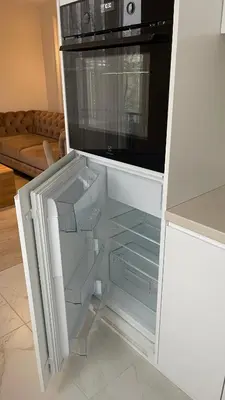 a kitchen with an open refrigerator with a microwave at Central Boulevard Apartment 2 in Šiauliai