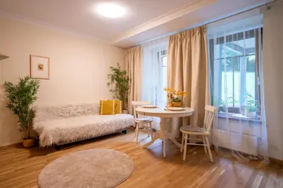 a living room with a couch and a table at Cozy Suite Roomita in Vilnius