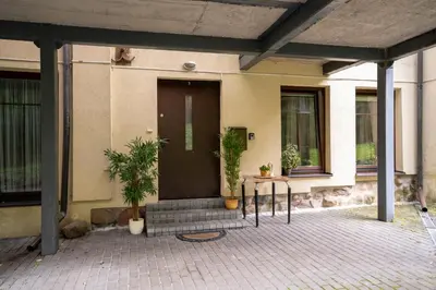a front door of a house with potted plants at Cozy Suite Roomita in Vilnius
