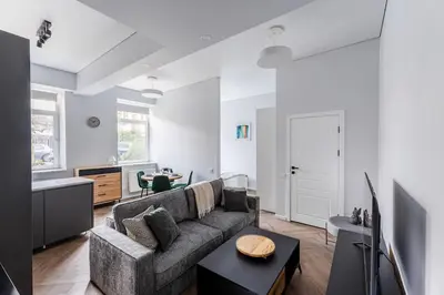 a living room with a couch and a table at Modern flat in Old Town Kaunas - Parking & Self Check-In in Kaunas