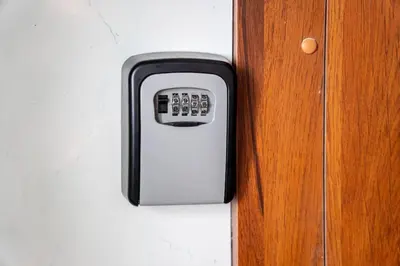 a remote control sticking out of a wooden door at Modern flat in Old Town Kaunas - Parking & Self Check-In in Kaunas