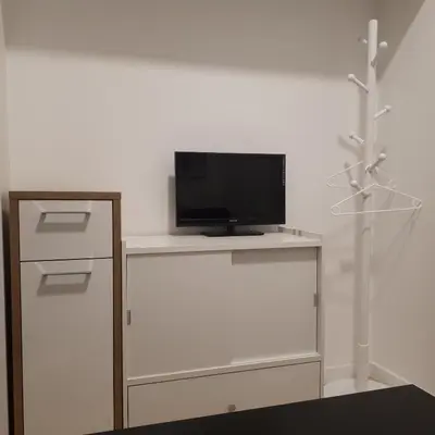 a tv sitting on top of a white table at Mini apart Žvėrynas in Vilnius