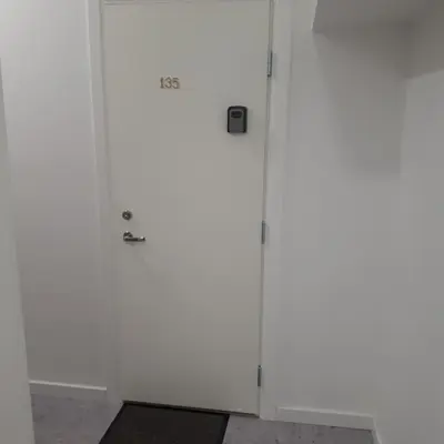 a white cabinet with a door in a room at Mini apart Žvėrynas in Vilnius