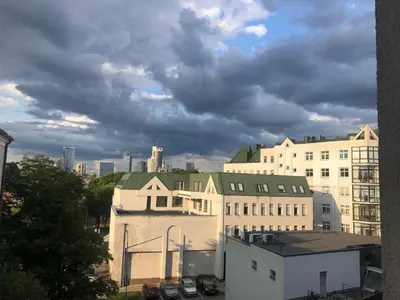 a group of buildings in a city under a cloudy sky at G-45 in Vilnius