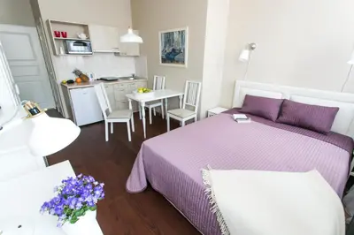 a bedroom with a bed and a table with purple sheets at G-45 in Vilnius
