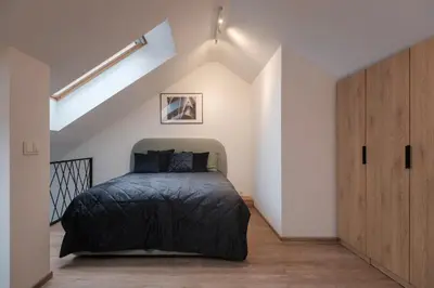 a bedroom with a bed in a attic at Butas-loftas mieste, Kaunas in Kaunas