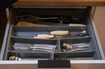 a drawer full of utensils in a cabinet at Butas-loftas mieste, Kaunas in Kaunas