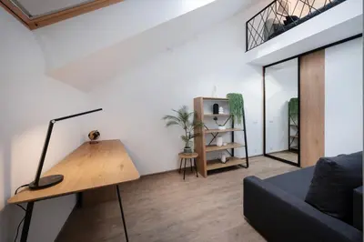 a living room with a couch and a table at Butas-loftas mieste, Kaunas in Kaunas