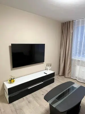 a living room with a large flat screen tv on the wall at Naujai įrengtas butas trumpalaikei nuomai in Šiauliai