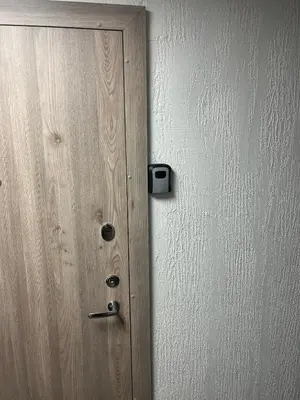 a wooden door with a black box on it at Naujai įrengtas butas trumpalaikei nuomai in Šiauliai