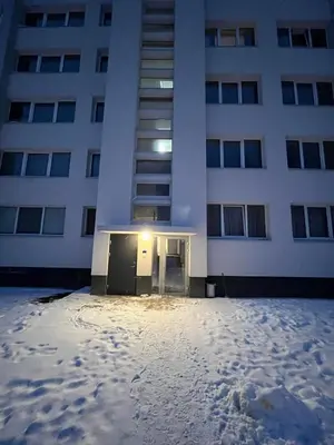 a large building with snow in front of it at Naujai įrengtas butas trumpalaikei nuomai in Šiauliai