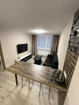 a living room with a couch and a table at Naujai įrengtas butas trumpalaikei nuomai in Šiauliai