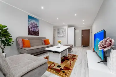 a living room with a couch and a table at Stylish Apartment For up to 4 Guests With WiFi, Free Parking in Vilkaviškis