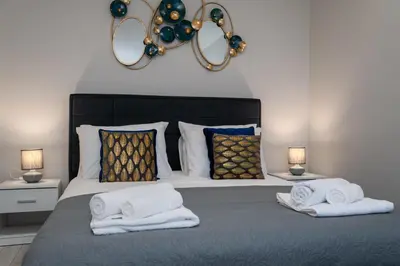 a bedroom with a bed with towels on it at Stylish Apartment For up to 4 Guests With WiFi, Free Parking in Vilkaviškis