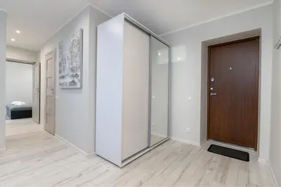 a hallway with white walls and a sliding glass door at Stylish Apartment For up to 4 Guests With WiFi, Free Parking in Vilkaviškis
