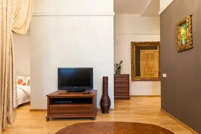 a living room with a television on a wooden table at Central apartments 2 x Free Parking x SELF CHECK-IN 24h by H&H in Vilnius