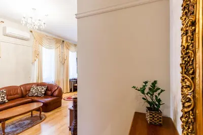 a living room with a couch and a mirror at Central apartments 2 x Free Parking x SELF CHECK-IN 24h by H&H in Vilnius
