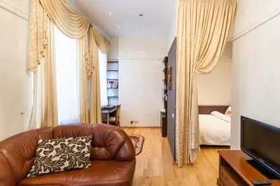 a living room with a couch and a bed at Central apartments 2 x Free Parking x SELF CHECK-IN 24h by H&H in Vilnius