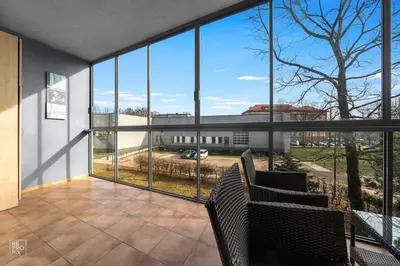 a room with large windows and a view of a building at Apartment with cozy balcony by URBAN RENT in Kaunas