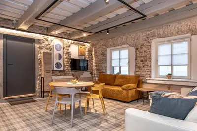 a living room with a couch and a table at Historic Bliss In Vilnius Old Town in Vilnius