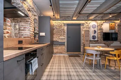 a kitchen with a table and a dining room at Historic Bliss In Vilnius Old Town in Vilnius