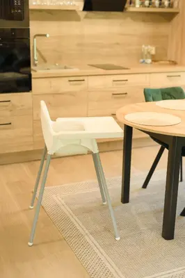 a white chair sitting next to a table in a kitchen at 