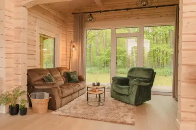 a living room with a couch and two chairs at 