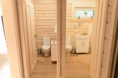 a bathroom with two toilets and a sink at 