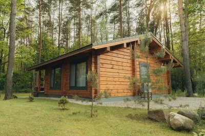 a log cabin in the woods with trees at 