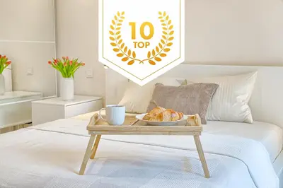 a coffee table with a tray of food on a bed at Business-class apartments 2 x Free Parking x SELF CHECK IN 24x7 in Vilnius