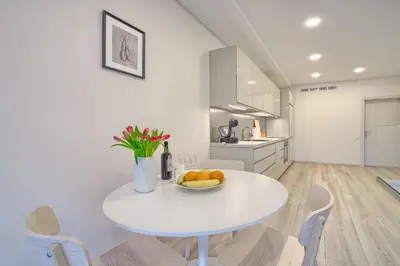 a white table in a kitchen with a bowl of fruit at Business-class apartments 2 x Free Parking x SELF CHECK IN 24x7 in Vilnius