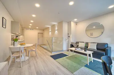 a living room with a couch and a table at Business-class apartments 2 x Free Parking x SELF CHECK IN 24x7 in Vilnius