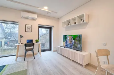 a living room with a flat screen tv on a wall at Business-class apartments 2 x Free Parking x SELF CHECK IN 24x7 in Vilnius