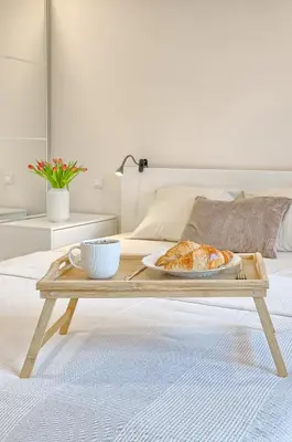 a tray with a plate of croissants on a table at Business-class apartments 2 x Free Parking x SELF CHECK IN 24x7 in Vilnius