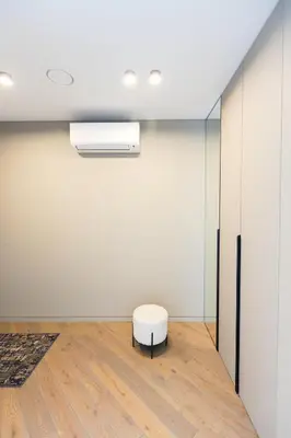 a stool in a room with a white wall at Brand New Central Panorama (SELF CHECK-IN) in Vilnius